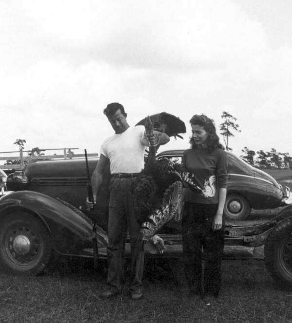 Man displaying his turkey prize at Naples' Swamp Buggy Day.