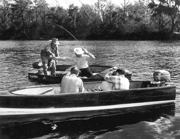 Movie camera operators filming fishing in the Suwannee River .