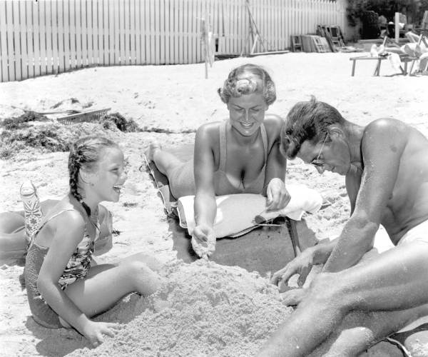 Family plays in the sand at the beach