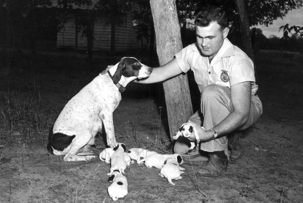 Forrest Davis Jr with a dog and puppies - Quincy, Florida