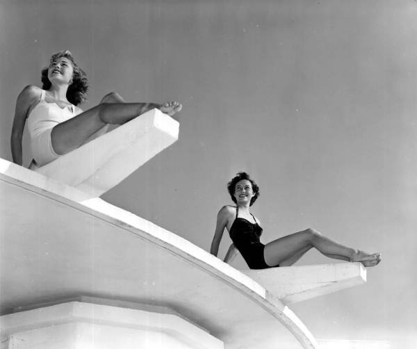 Barbara Hoots and Paula Gaines pose atop a concrete structure at Lido Beach - Sarasota, Florida.