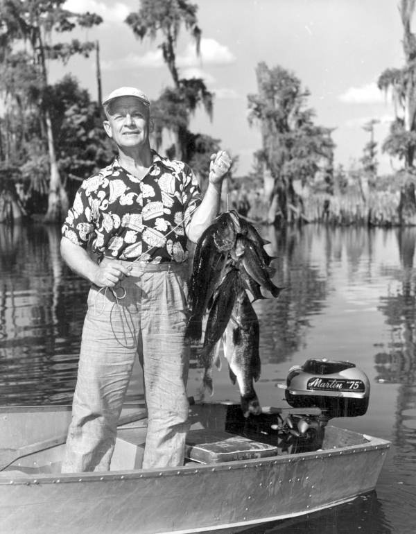 Colonel Thompson displaying his catch of fish at Dead Lakes