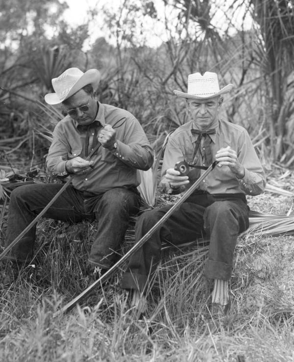 Cowboys preparing polo sticks from palmettos - New Smyrna Beach, Florida.
