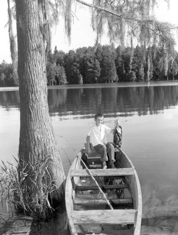 Young boy proudly displaying his string of fish caught at Lake Munson - Tallahassee, Florida.