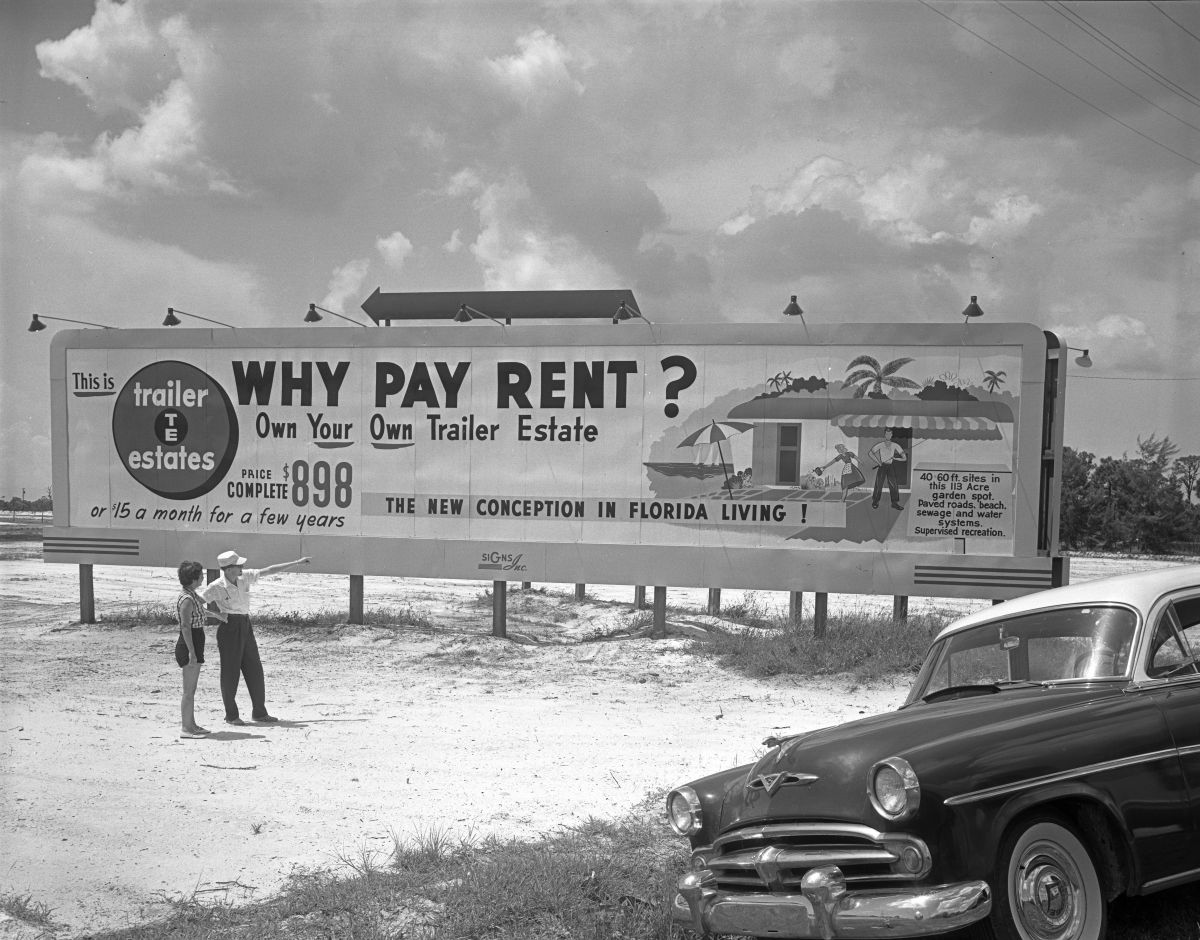 Unidentified couple looks at the Trailer Estates' sign - Bradenton, Florida