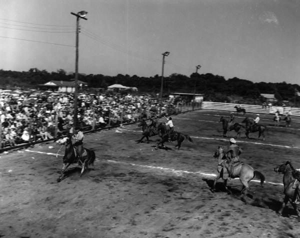 Cowboys and horses on the field at the Cowpony Frolics - New Smyrna Beach, Florida.