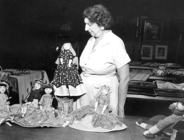 Unidentified woman with display of handmade rag dolls - Miami, Florida