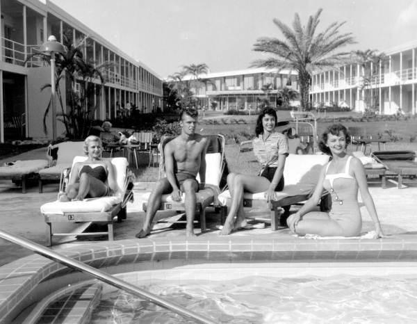 People enjoying the sun at poolside - Saint Petersburg Beach, Florida.