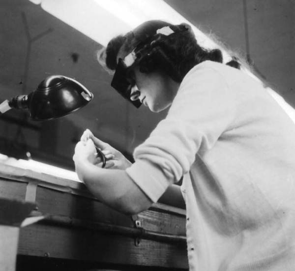Mrs. Charlotte Miskinis adjusts tiny wires on coil..
