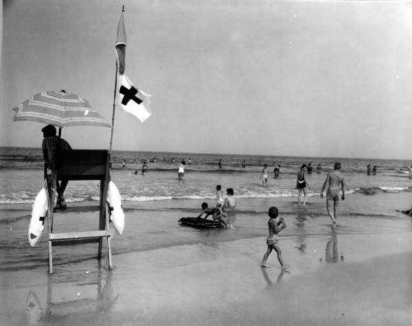 Beach-goers by life guard stand.
