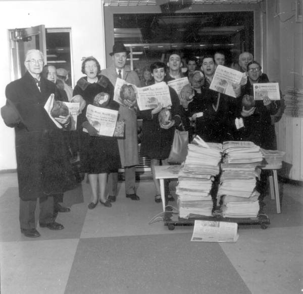 Group holding up the Miami Herald during newspaper strike in New York.