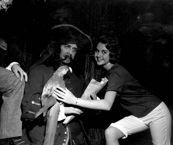 Cheryl Aurland poses with a pirate and parrot displayed at the London Wax Museum - Saint Petersburg Beach, Florida