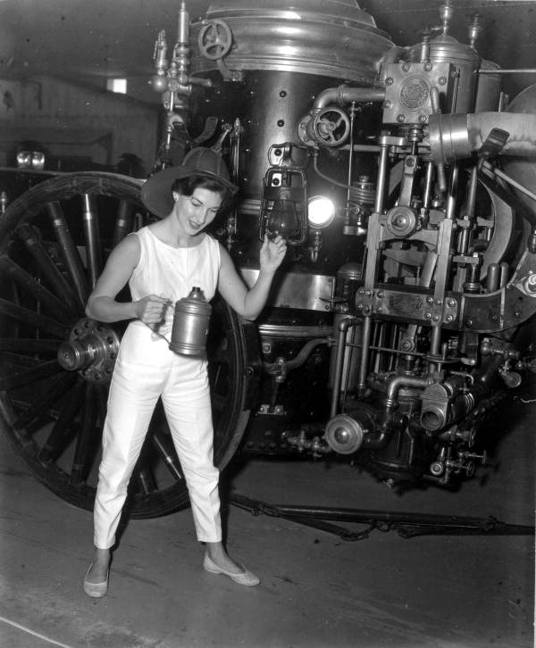 Deane Martin standing near early fire engine - Silver Springs, Florida.