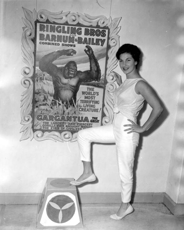 Deane Martin standing near circus poster- Silver Springs, Florida.