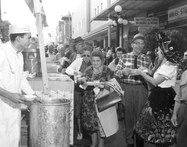 Large crowd being served bean soup during the Gasparilla Carnival - Tampa, Florida.
