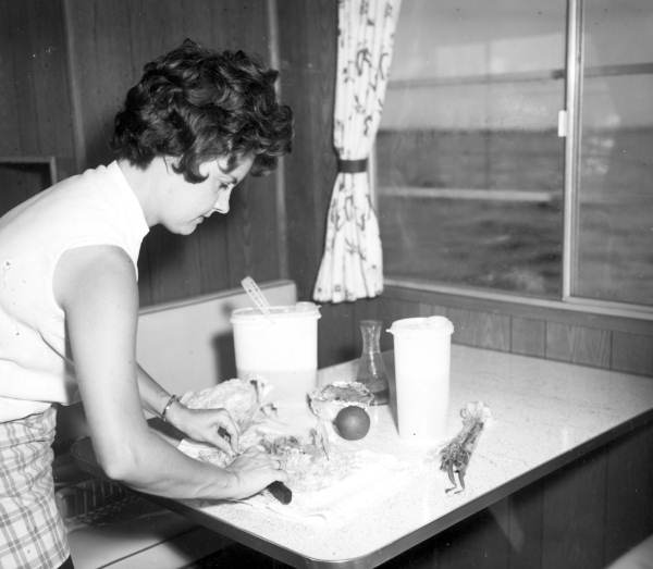 Woman preparing food on a houseboat on the Kissimmee River