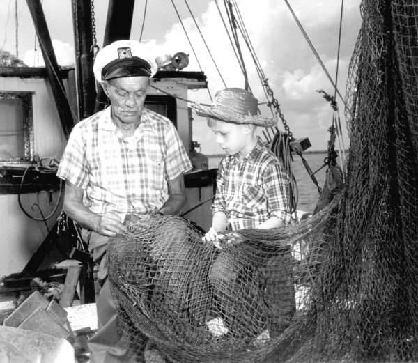 Bradie Parrish and Palmer Philyaw working on fishing net