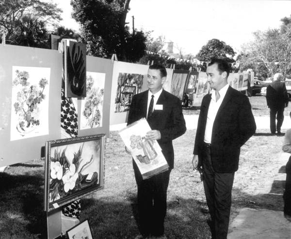 Men admiring artwork at the Florida Seafood Festival - Apalachicola, Florida