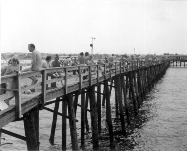 A crowd of people fishing on the pier - Jacksonville Beach, Florida.