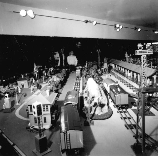 A family viewing a model exhibit at the Lionel Train Museum - Sarasota, Florida
