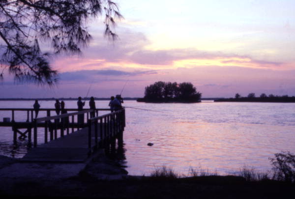 View showing people fishing from a dock at Sebastian Inlet State Park - Melbourne Beach, Florida.