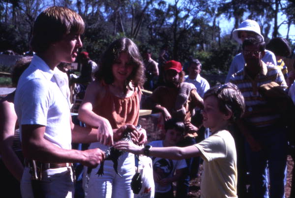 Visitors petting baby alligator at the Cypress Gardens theme park in Winter Haven, Florida.