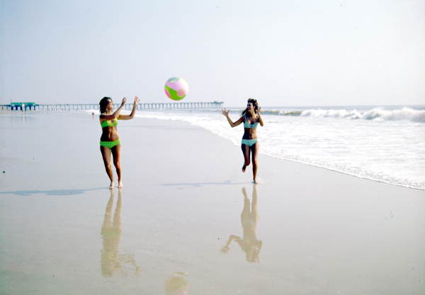 Women in bikinis playing with a beach ball - Jacksonville, Florida