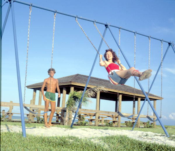 Boy pushing girl on swing - Fort Pierce, Florida
