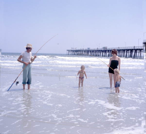 Family fishing at the beach by the pier - Jacksonville Beach, Florida
