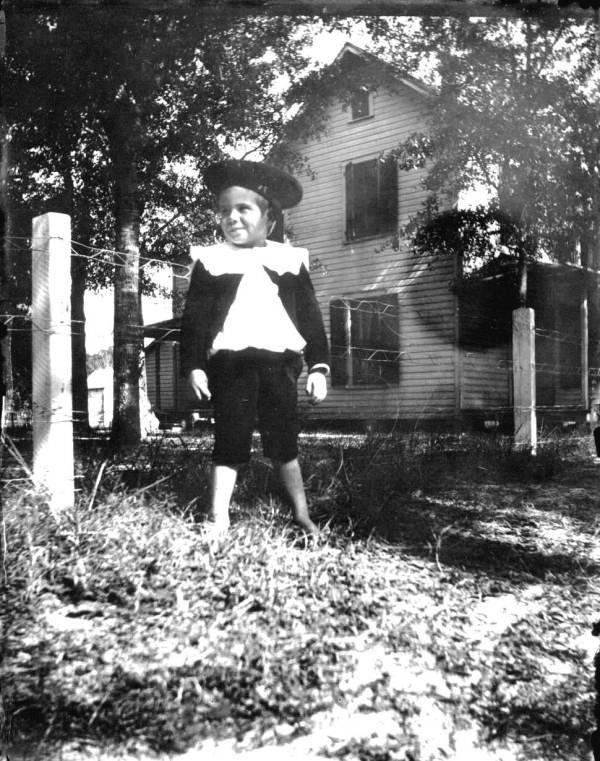 Barefoot boy dressed in his Sunday best
