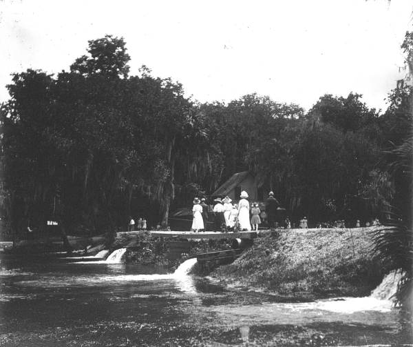 Men and women walking along the bank of De Leon Springs