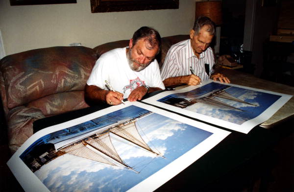 Artist George Carey and Captain Dick Steadman co-signing prints from a painting - Key West, Florida.