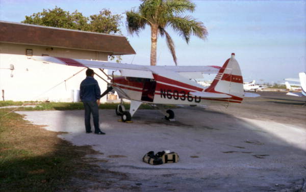 Dale McDonald with Jake Roberson's airplane at the Key West Airport in preparation for a photo flight..