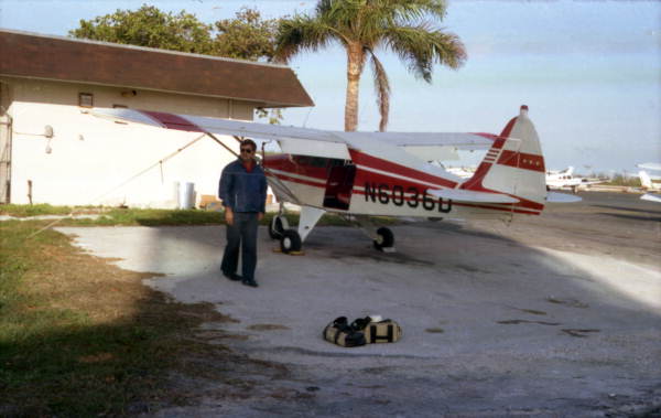 Dale McDonald with Jake Roberson's airplane at the Key West Airport in preparation for a photo flight..