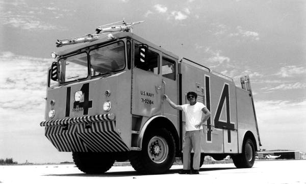 Naval Air Station Key West firefighter Dale McDonald along side a 1971 Oshkosh MB-1 crash truck on the "Hot Spot" at mid-field, NAS Key West..