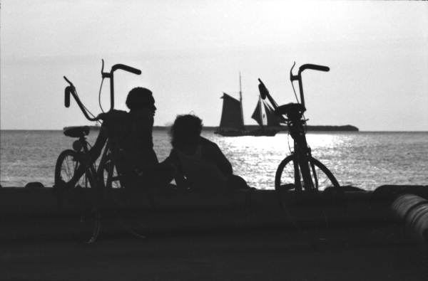 Couple enjoys view of sunset from Mallory Square, Key West, FL..