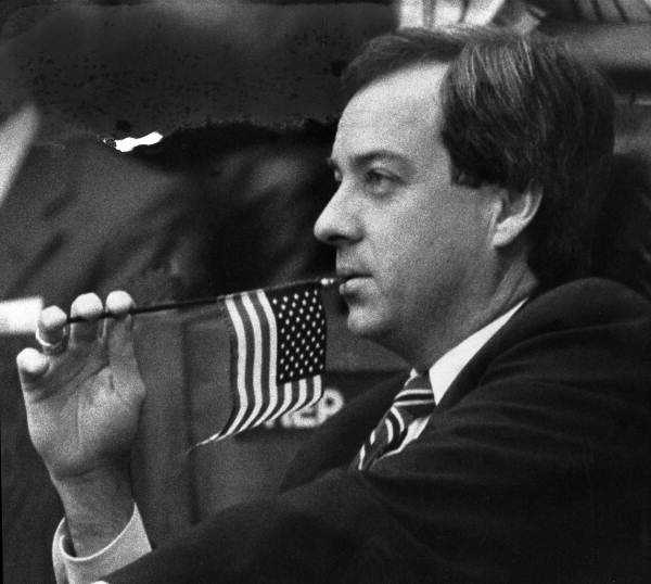 Rep Mike Langton, D-Jacksonville, chews on the tip of a stick holding a miniature flag - Tallahassee, Florida.