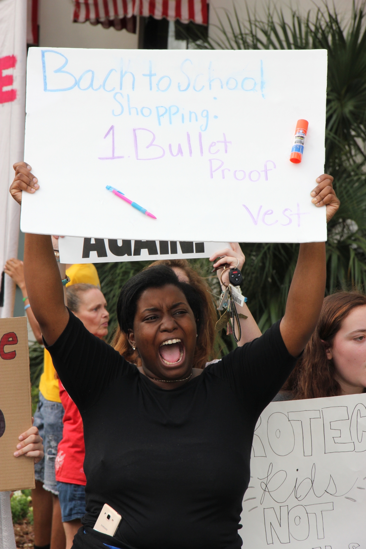 Student demonstrator with her sign at the Old Capitol during the Never Again Rally in Tallahassee.