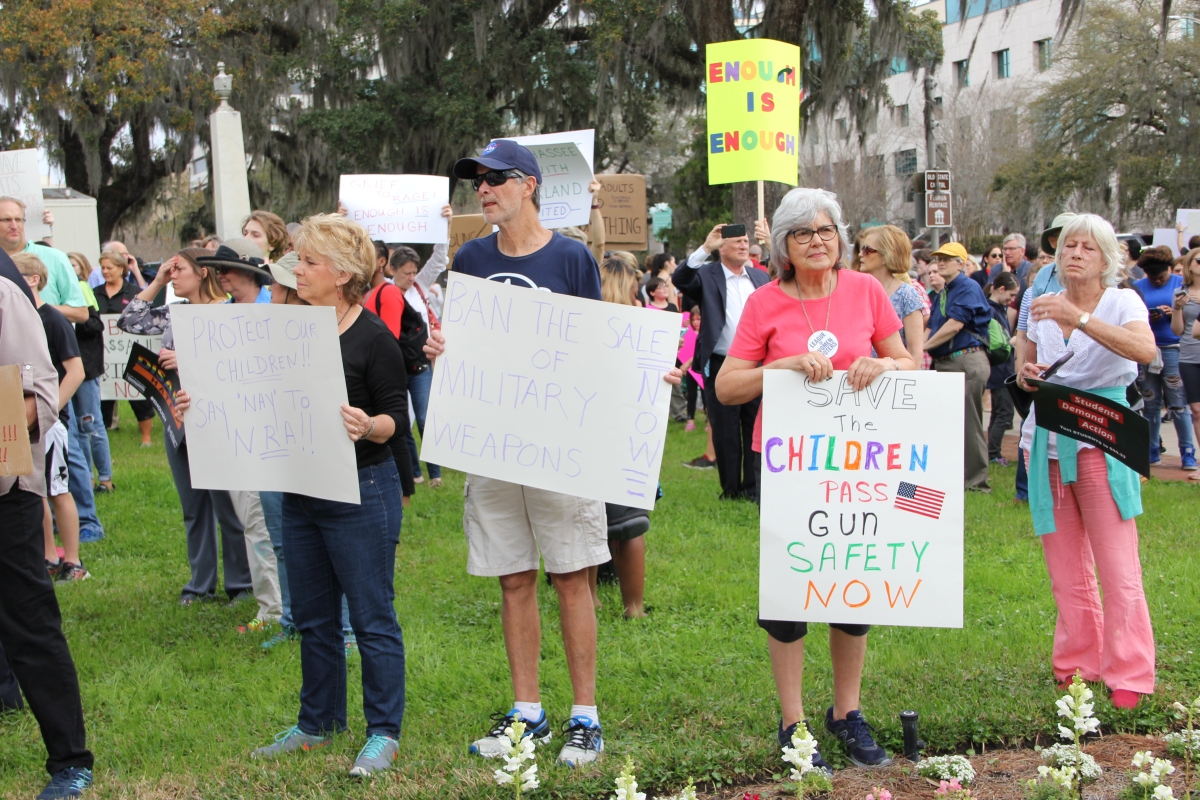 Gun-control activists with their signs at the Old Capitol during the Never Again Rally in Tallahassee.