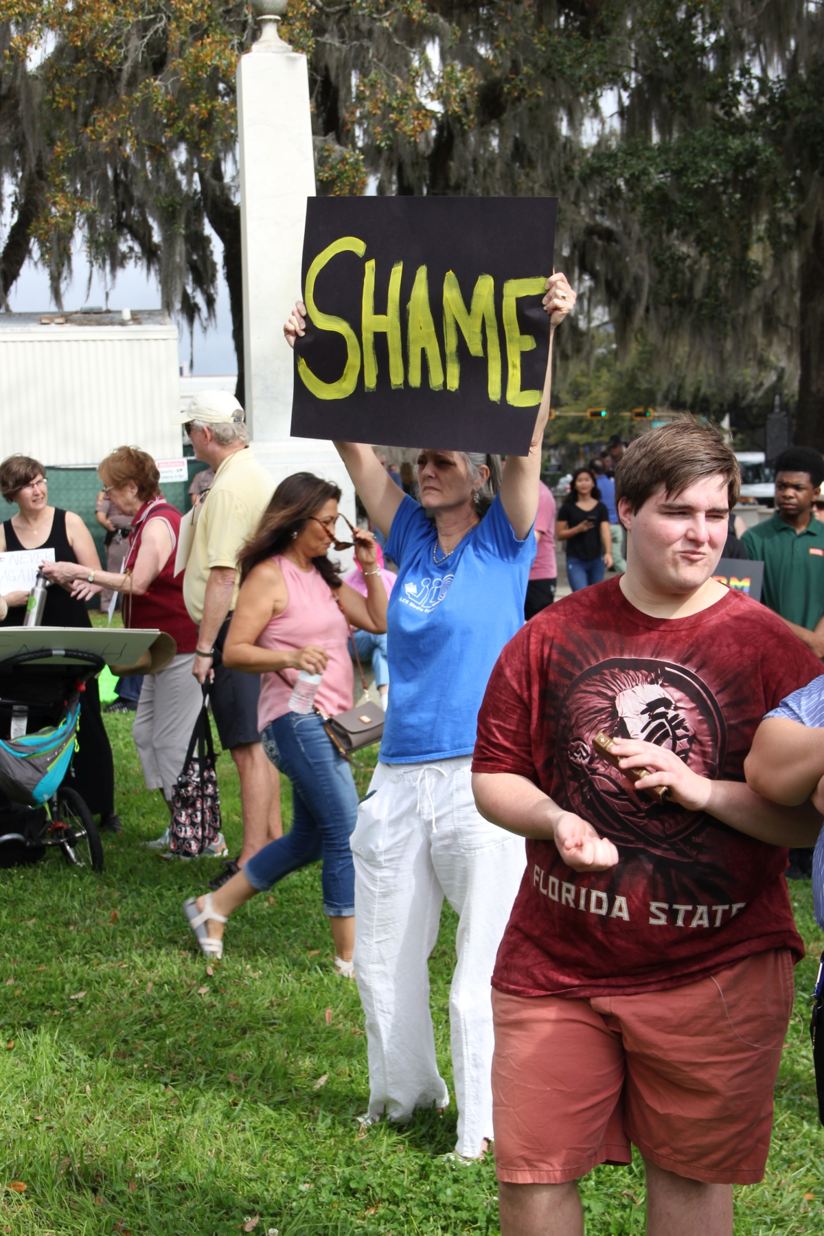 Gun-control activist holding up her sign at the Never Again Rally in Tallahassee.