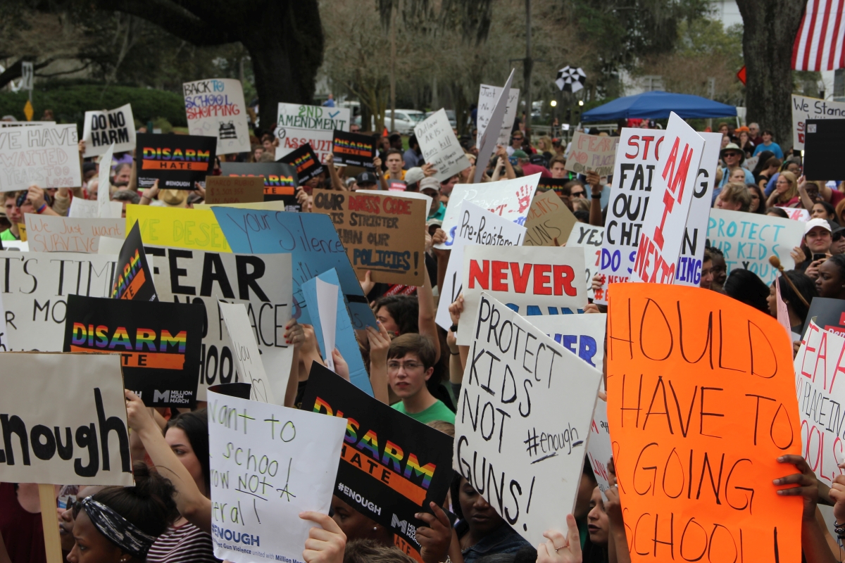 Close-up view showing student demonstrators with their signs at the Never Again Rally in Tallahassee.