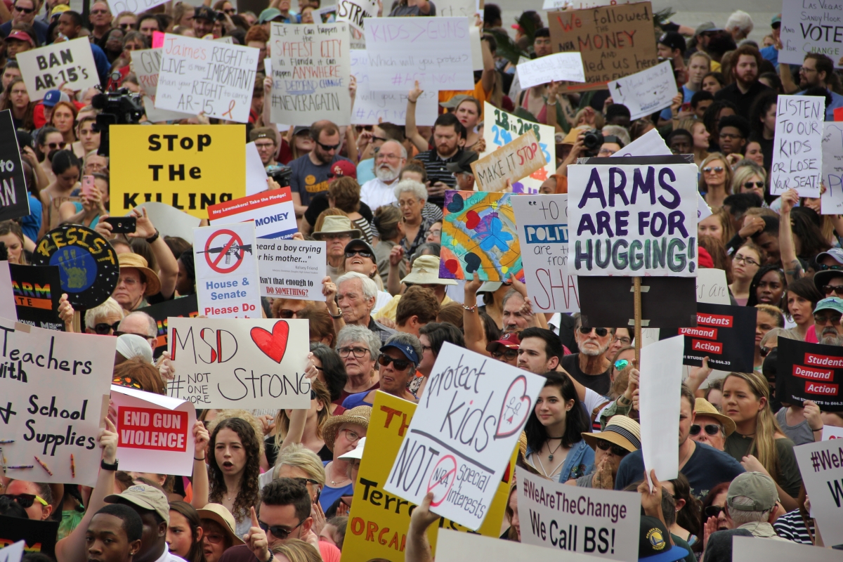 Student demonstrators and gun-control activists holding up their signs at the Never Again Rally in Tallahassee.