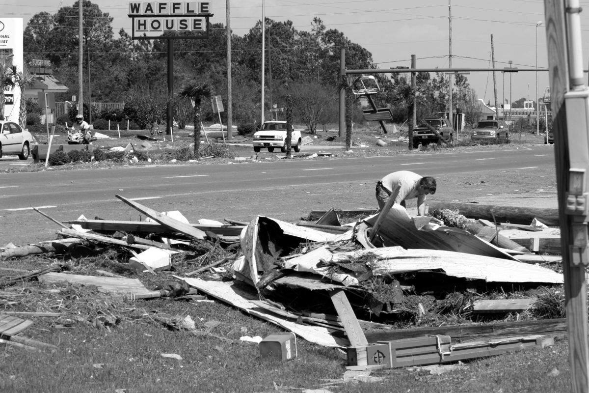 Man goes through storm wreckage after Hurricane Ivan - Navarre, Florida.