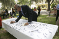 Reverend Henry Steele signing a banner during the Emancipation Day Celebration at the Knott House Museum in Tallahassee.