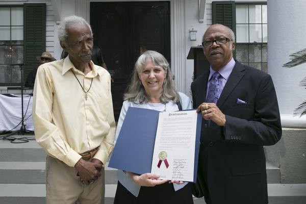 Steele brothers posing with Jeana Brunson holding a proclamation commemorating Emancipation Day 2015.