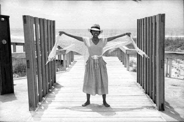 Fashion model on the boardwalk at the beach.