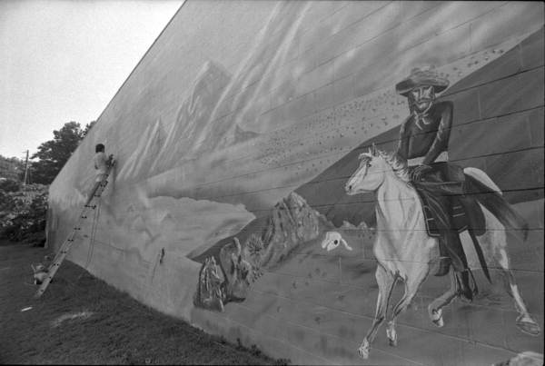 Painter works on Gabes Mural - Tallahassee, Florida.