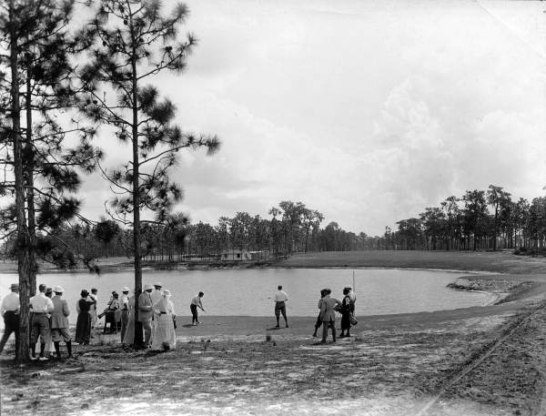 View showing golf being played on the Miami Biltmore Hotel and Country Club golf course in Coral Gables, Florida.