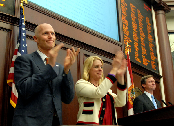 Florida's Governor Rick Scott, left, along with Attorney General Pam Bondi and House Speaker Dean Cannon, R-Winter Park, applauding passage of the drug bill in the House.