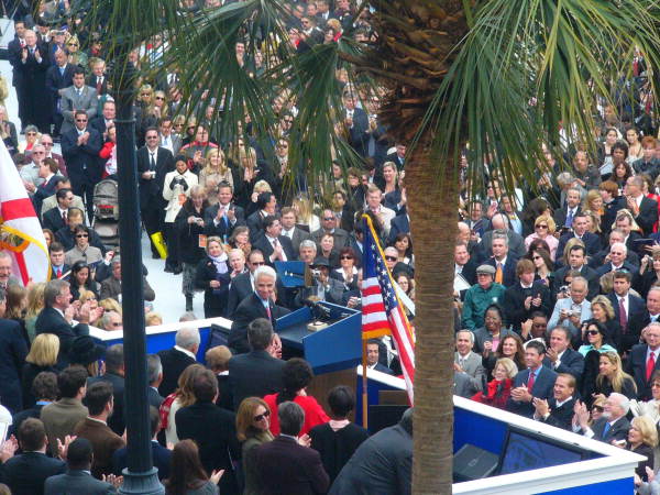 Governor Charlie Crist receiving applause at the podium during his inauguration while looking toward departing Governor Jeb Bush - Tallahassee, Florida.